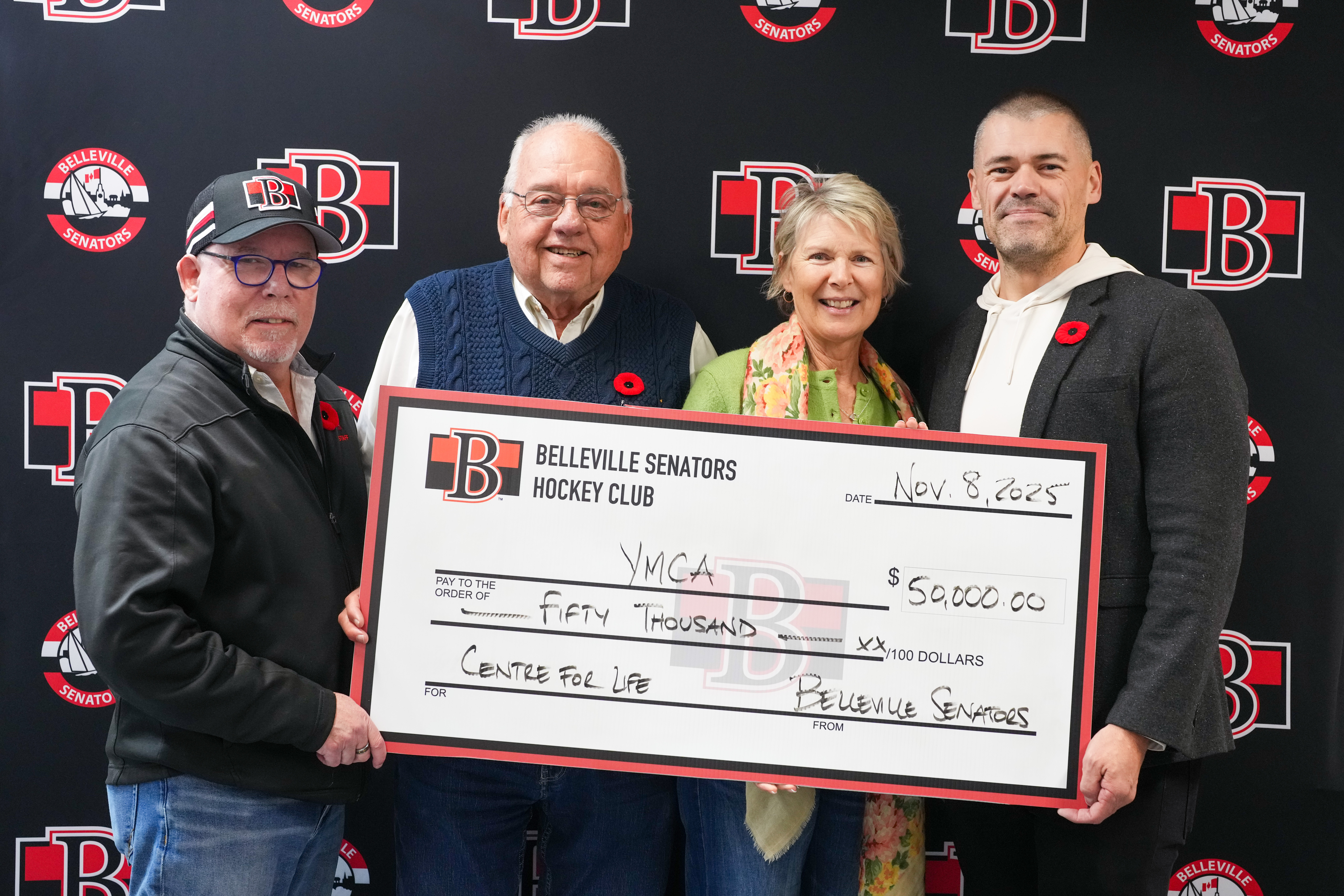 Members of the local YMCA receive a cheque for $50,000 from the Belleville Senators.