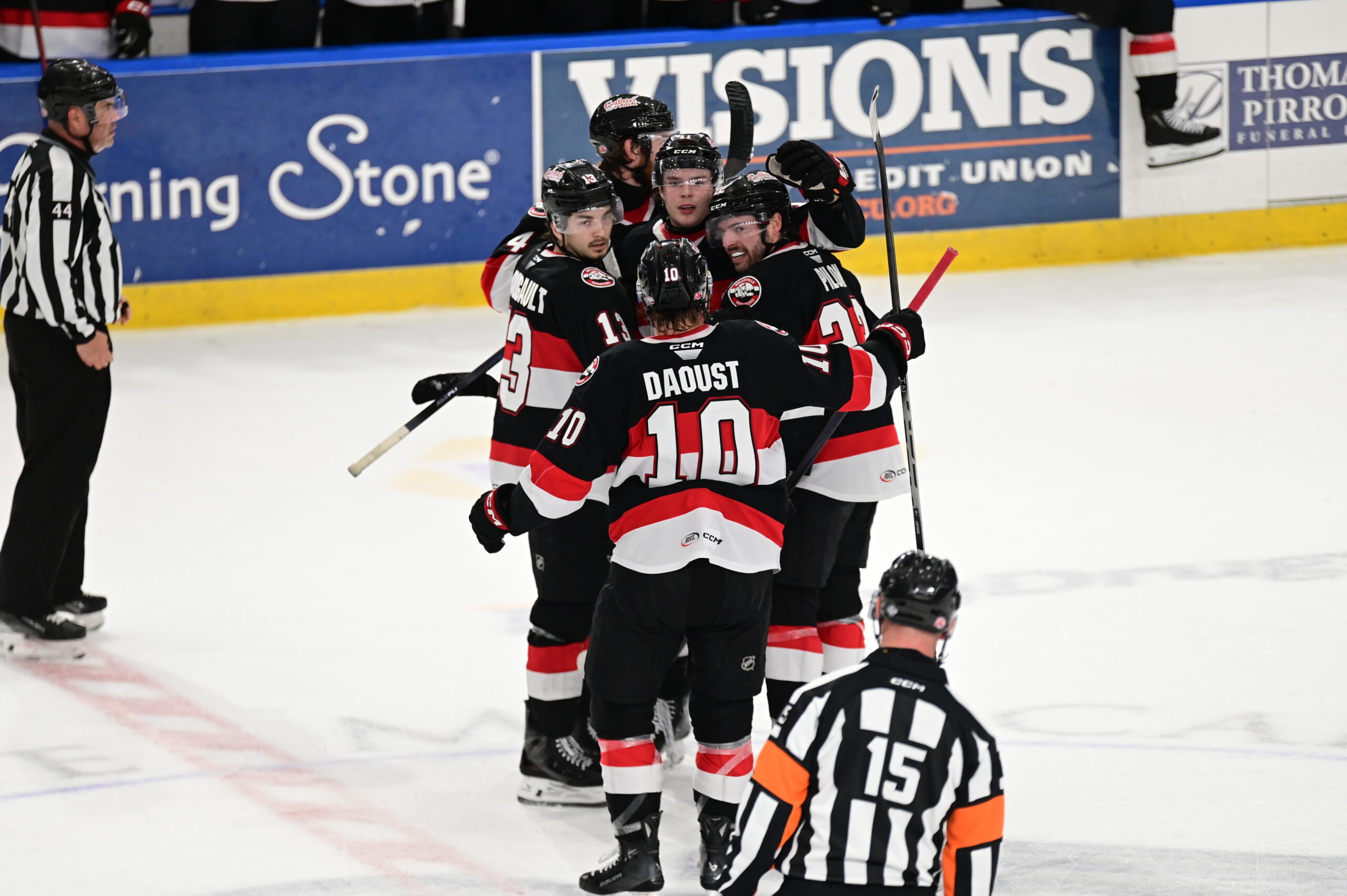 Belleville Senators players celebrate after a goal in Syracuse
